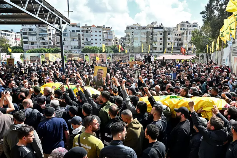 Mourners carry the flag-draped caskets of members of the Iran-backed militant group Hezbollah who were killed in southern Lebanon during their funeral in the Kafaat area, in Beirut's southern suburbs, on Monday.