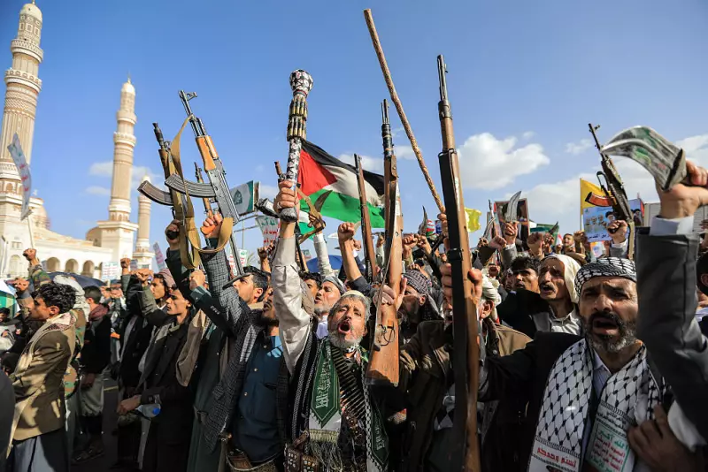 Supporters of the Iran-backed Houthi movement brandish their weapons as they rally in solidarity with Iran and Lebanon amid the U.S.-Israeli war with Iran, in Yemen's capital of Sanaa on Friday.
