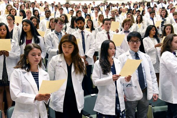 Incoming medical students from the Class of 2023 recite the Hippocratic Oath during the White Coat Ceremony at Albany Medical College on Tuesday, Aug. 6, 2019 in Albany, N.Y.