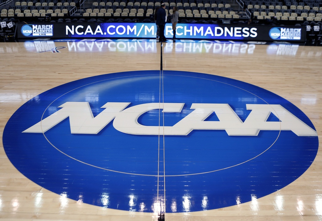 The NCAA logo is displayed in 2015 at center court at The Consol Energy Center in Pittsburgh. (AP)