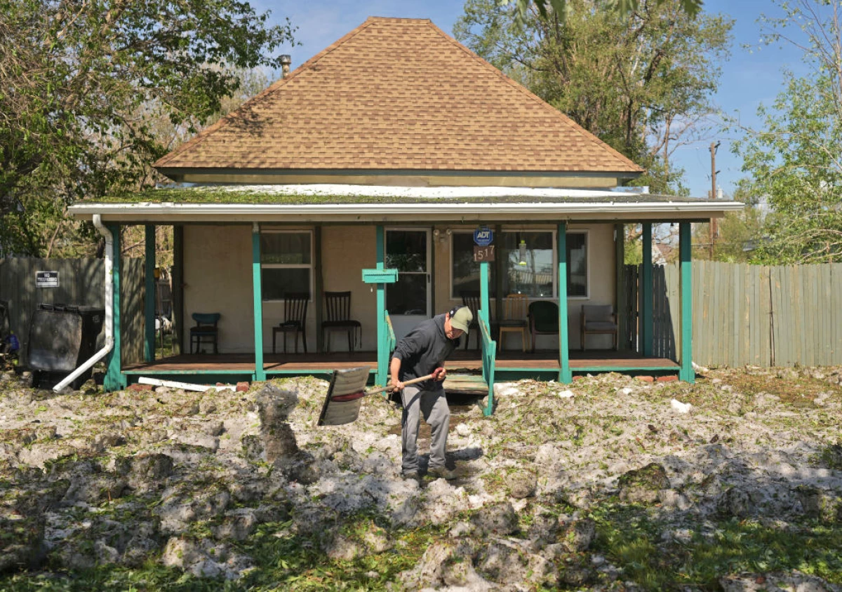 Marsden Rodon clears the walkway in front of the home he rents in a neighborhood southeast of downtown Greeley, Colo. after a severe hailstorm moved over the area in May 2024. North America has the most severe hail risk in the world.
