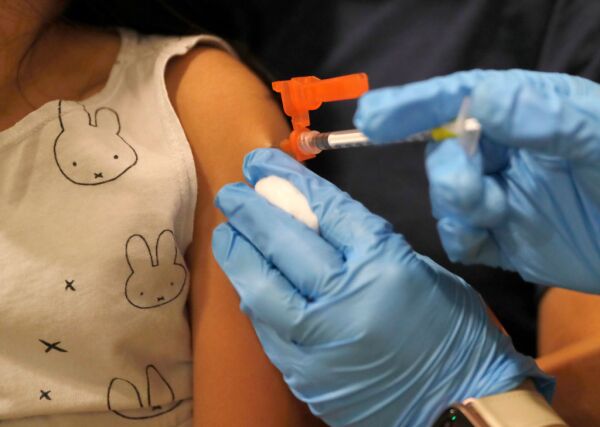 CDC Ends COVID Vaccine Recommendation: Kids & Pregnancy A medical professional prepares a COVID-19 vaccine dose.