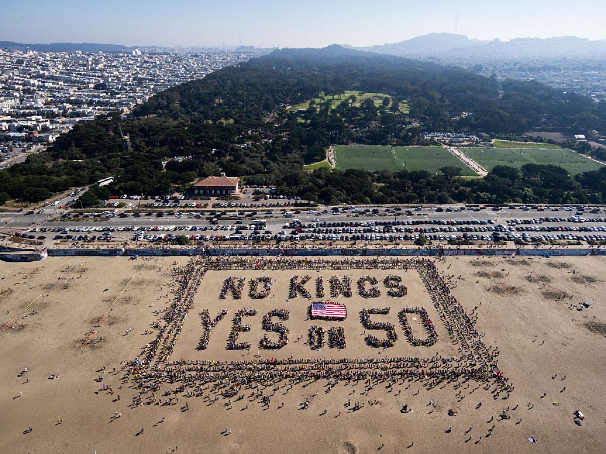 This aerial picture shows protesters forming a human banner during the 'No Kings' national day of protest on Ocean Beach in San Francisco, Calif. on Oct. 18, 2025.
