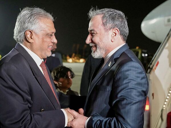 This handout photo released by the Iranian foreign ministry shows Pakistan's Foreign Minister Ishaq Dar (L) greeting his Iranian counterpart Abbas Araghchi upon his arrival in Islamabad on April 24, 2026.
