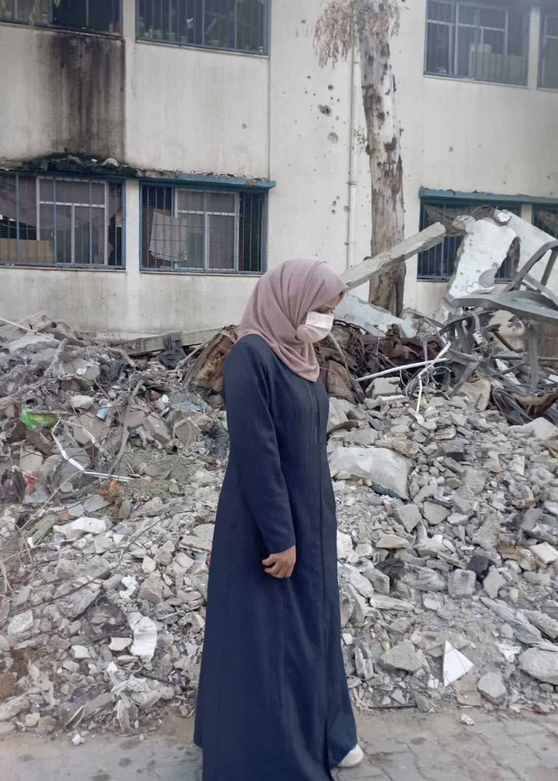 Taqwa Abusaeid stands amid the rubble of a destroyed building in Gaza City nearly a year after surviving the Oct. 31, 2023, Israeli airstrike that killed all her children and other relatives.