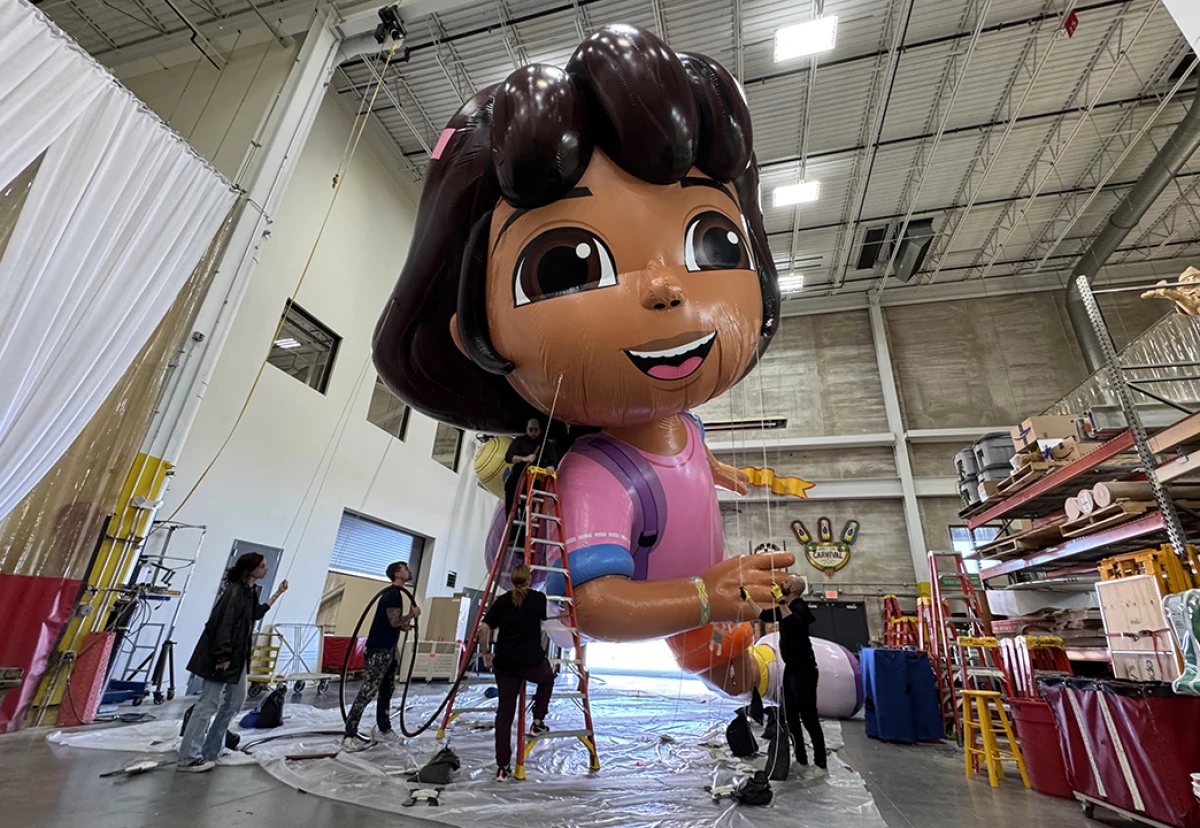 The Dora the Explorer balloon gets pumped up for a flight over the streets of New York City in the 98th Macy's Thanksgiving Day Parade.