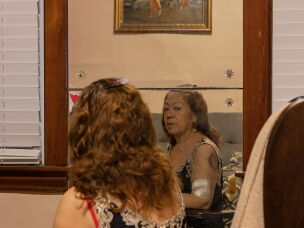 Teresa Chavez looks at herself in the mirror in 2022.