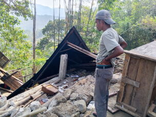 A man examines the damage to a building following an earthquake in East Manggarai, East Nusa Tenggara province, Indonesia, Saturday, Aug. 15, 2026.