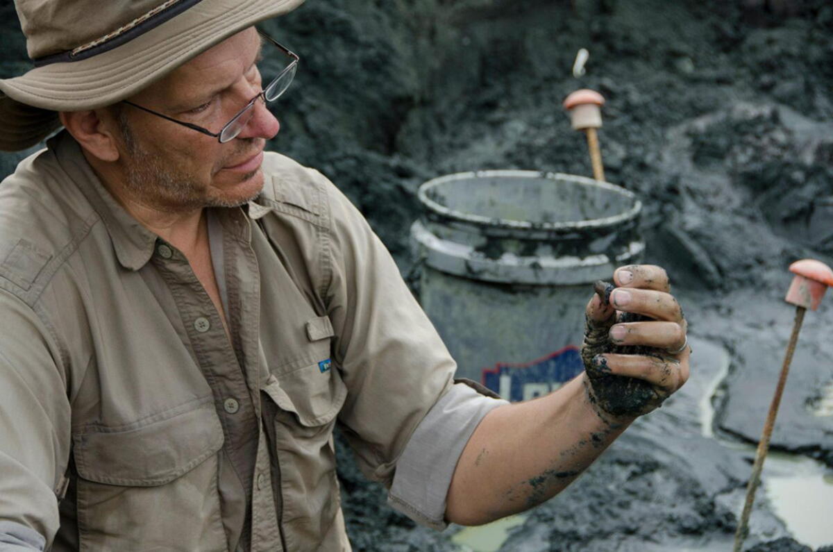 Ken Lacovara examining a fossil