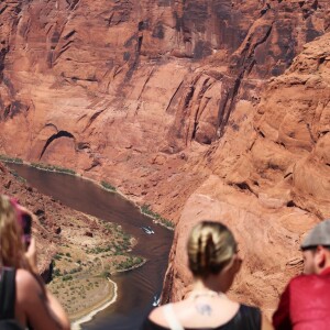 Tourists look out at the Colorado River at Horseshoe Bend in Page, Arizona on May 14, 2026. Water supplies are shrinking due to climate change and drought, and the new plan is an attempt to rein in demand.