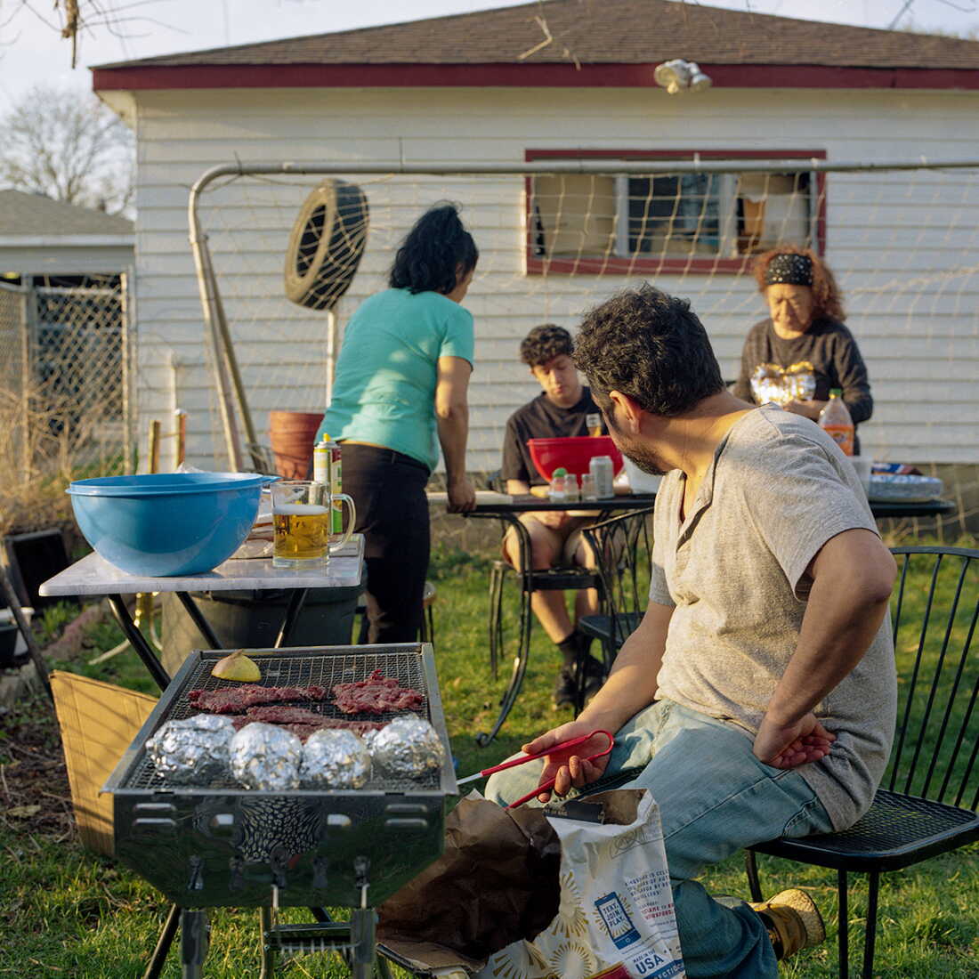 The Villanueva family grilling outside in their backyard in Chicago in 2025.