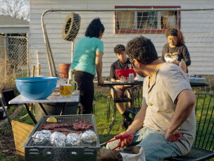 The Villanueva family grilling outside in their backyard in Chicago in 2025.