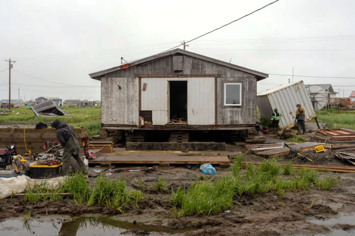Construction crews work on houses and other building throughout Kipnuk after ex-typhoon Halong hit Alaska