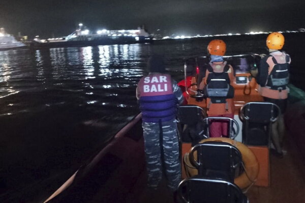 Rescuers search for victims after a ferry sank off Ketapang, East Java, Indonesia.