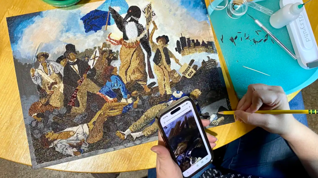 First-time crop artist Bethany Nagan works on a piece referencing the 1830 "Liberty Leading the People" by Eugène Delacroix and swaps Lady Liberty for a rebel loon on Aug. 19.