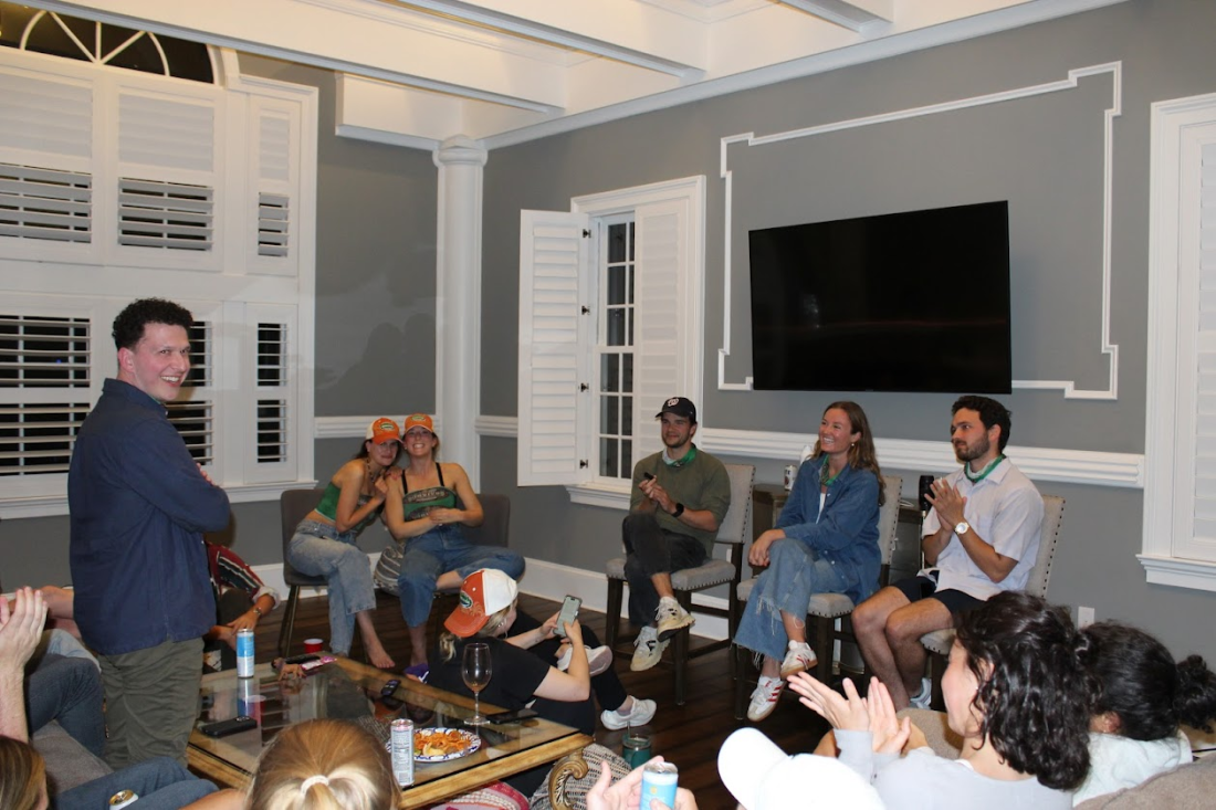 Tyler Pincus (left) questions the three finalists, seated under the television, during the last tribal council.