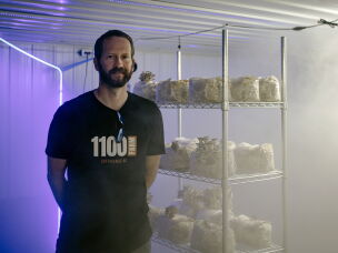 Tyler Faaborg stands in a fruiting room inside a former hog barn retrofitted to grow specialty mushrooms.