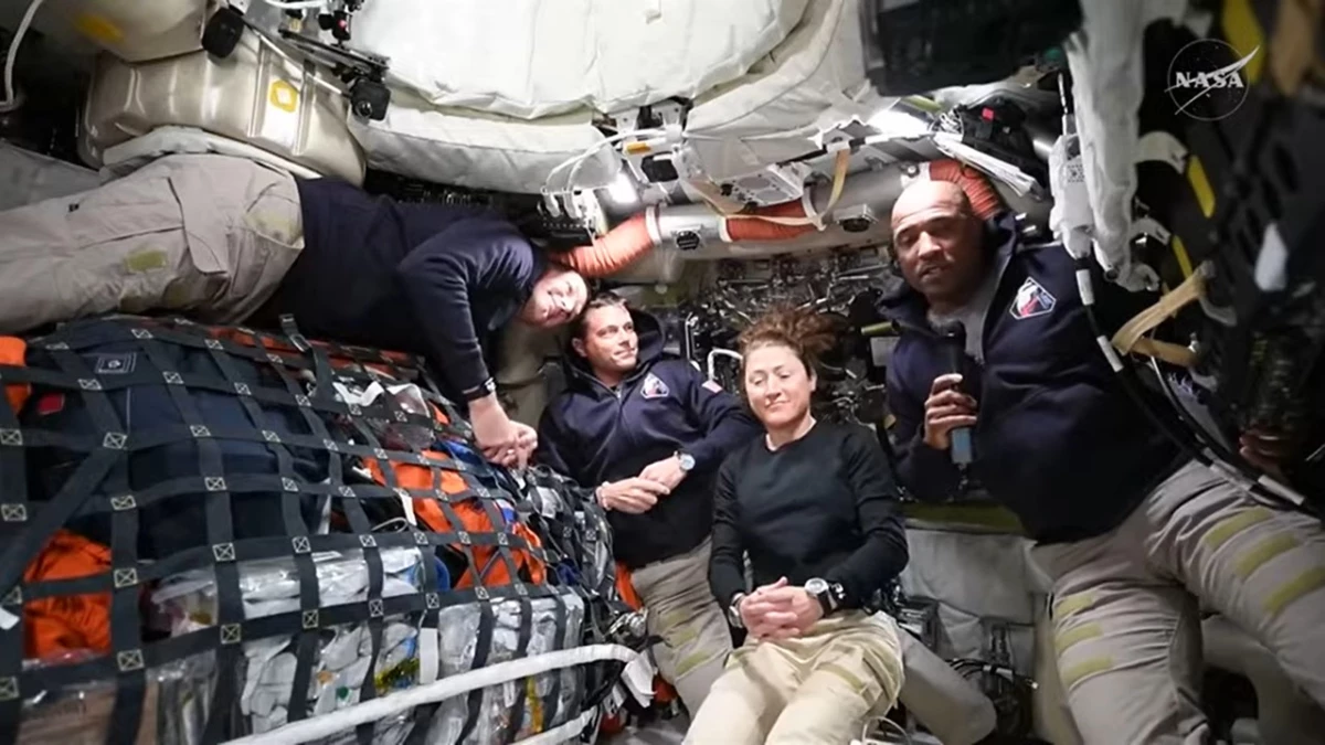 The four members of NASA's Artemis II crew (from left), Jeremy Hansen, Reid Wiseman, Christina Koch and Victor Glover, answer media questions from space during a news conference as they journey to the moon.