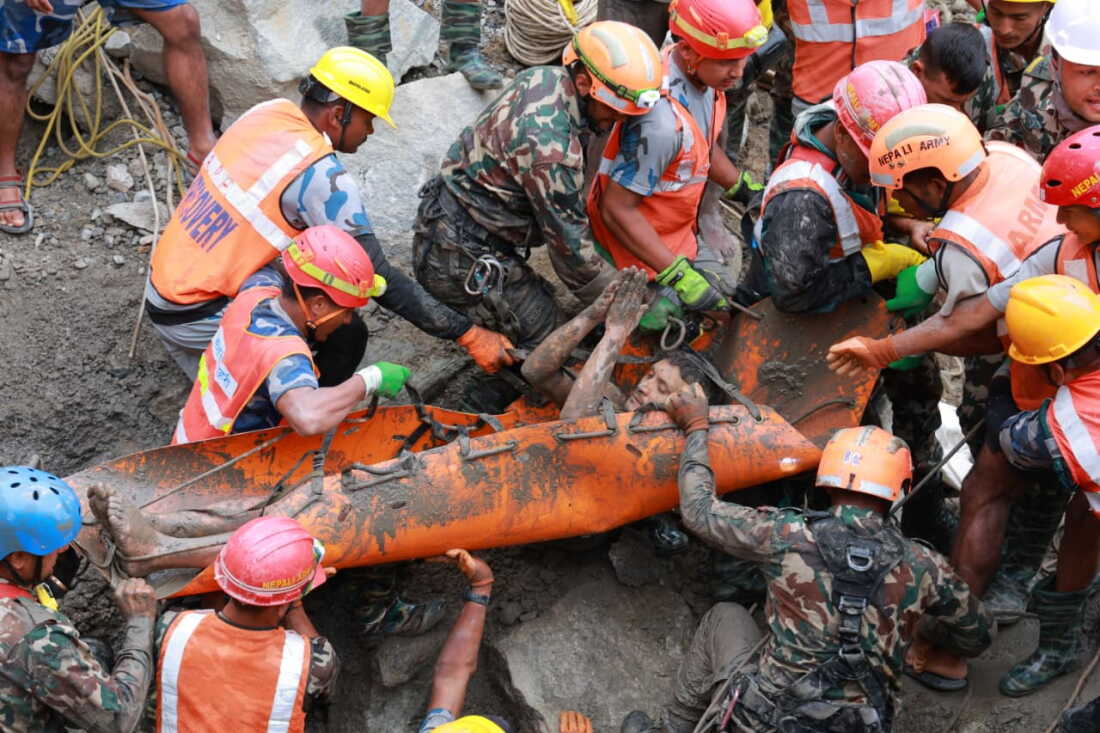 In this photo provided by the Nepal Army, soldiers rescue a worker alive from a tunnel during an ongoing operation at the Trishuli-3A hydropower project in Nepal's Rasuwa district, Friday.