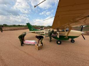 Virunga rangers unload supplies for the campaign to quash Ebola, including diagnostic kids and body bags.