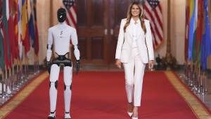 First lady Melania Trump arrivesaccompanied by a robotto attend the "Fostering the Future Together Global Coalition Summit," with other first spousesat the White HouseWednesdayMarch 252026in Washington.