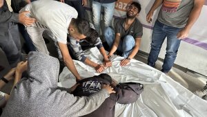 Palestinians grieve relatives who were killed in an Israeli airstrike on an encampment for displaced people on Sunday, May 26, in the southern Gaza city of Rafah.