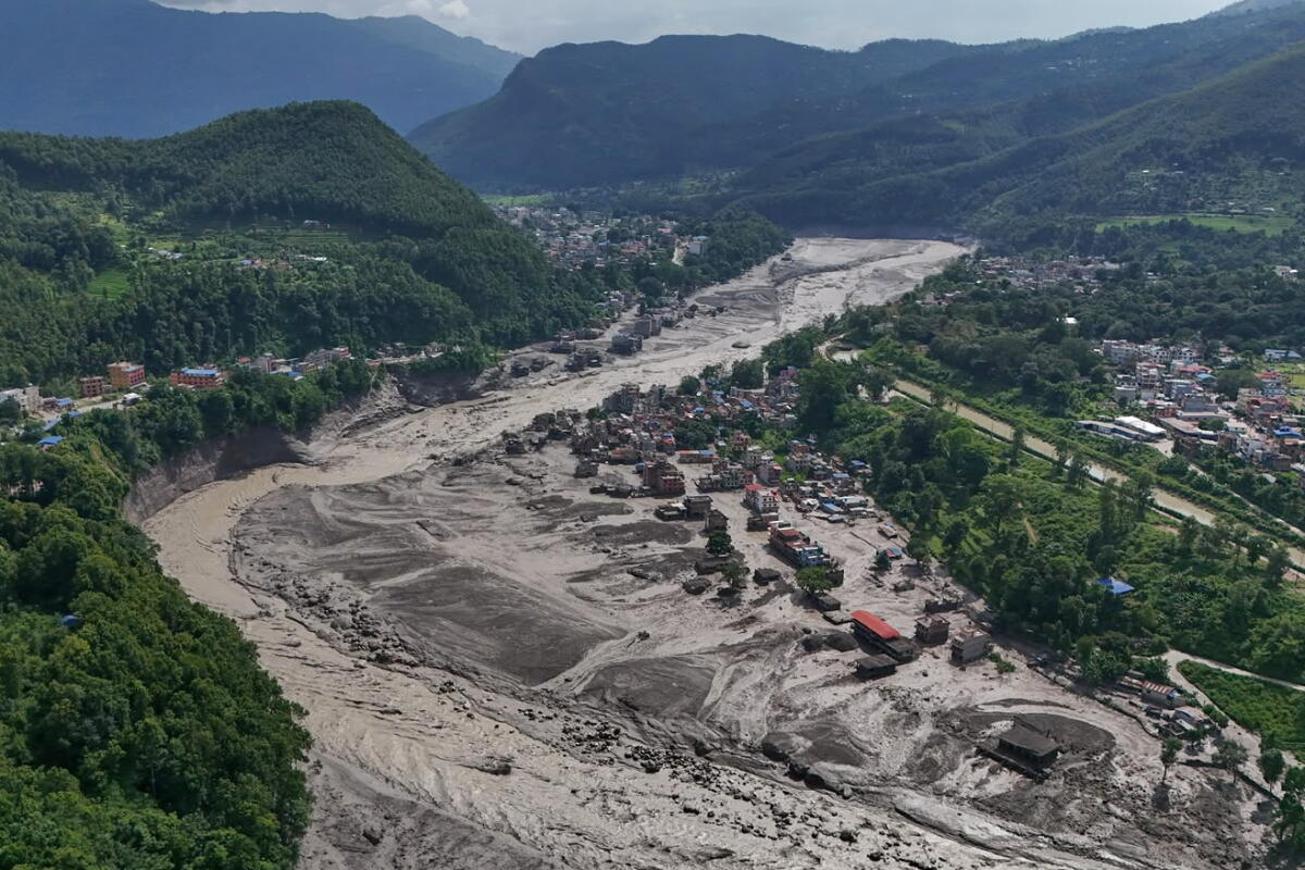 A melting glacier contributed to the deadly Nepal floods. We can expect more like this 1 Damaged houses stand precariously near the swollen, debris-choked banks of the Trishuli River after flash floods in Nepal's Nuwakot district on Wednesday.
