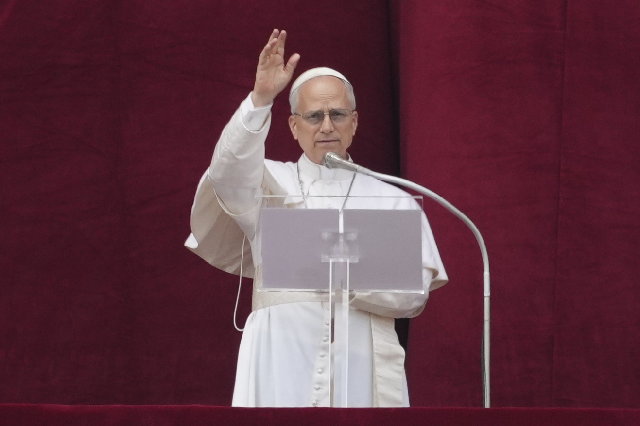 Pope Leo XIV delivers his blessing from the central balcony of St. Peter