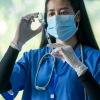 Flu season has started early, so consider getting vaccinated as soon as possible: NPR 3 The doctor uses a needle syringe to take an injection from the vaccine vial, Successful, safe and effective vaccines, The power of science against the COVID-19 virus.