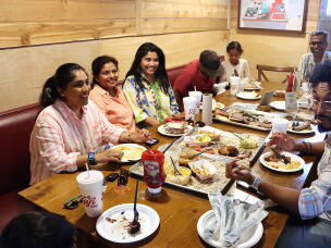 Areeba Ali (third from left) eats at Kafi BBQ with family in Irving, Texas.