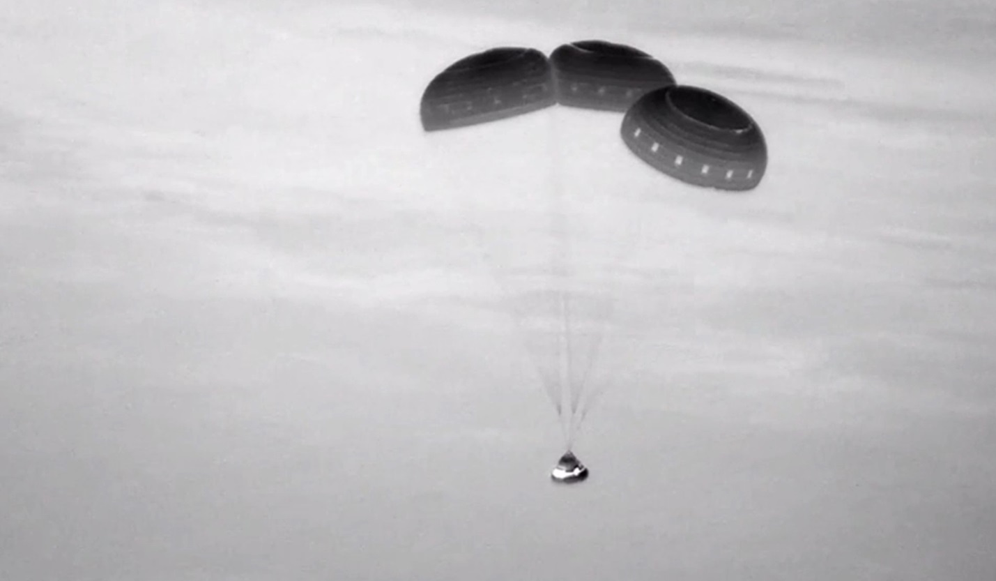  This image, taken from NASA video, shows the Boeing Starliner capsule coming down through the darkness over New Mexico. 