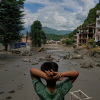 After Nepal floods, a daughter waits for word from her parents : NPR 2 A boy looks at the devastation caused by flash flooding along the Trishuli River in Nepal's Nuwakot district on Wednesday.