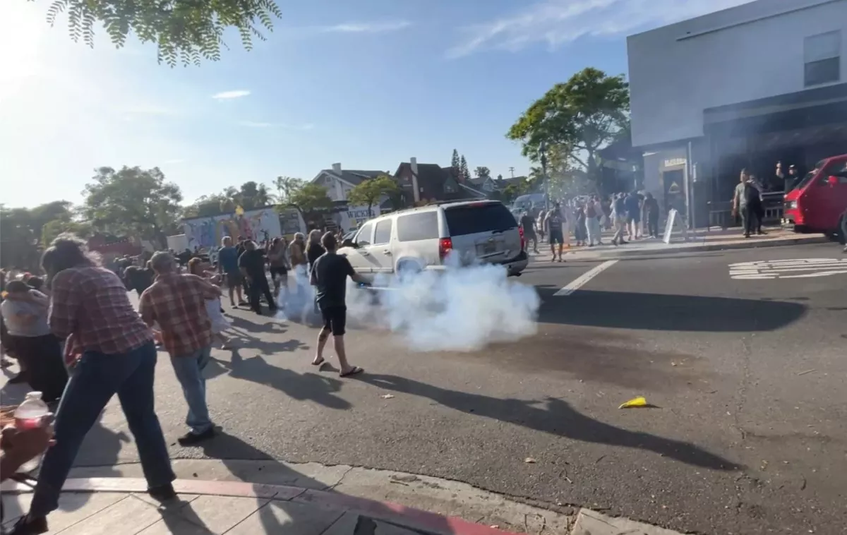 ICE agents used what appeared to be a smoke device to disperse the crowd near Buona Forchetta in San Diego, Calif., on May 30, 2025.