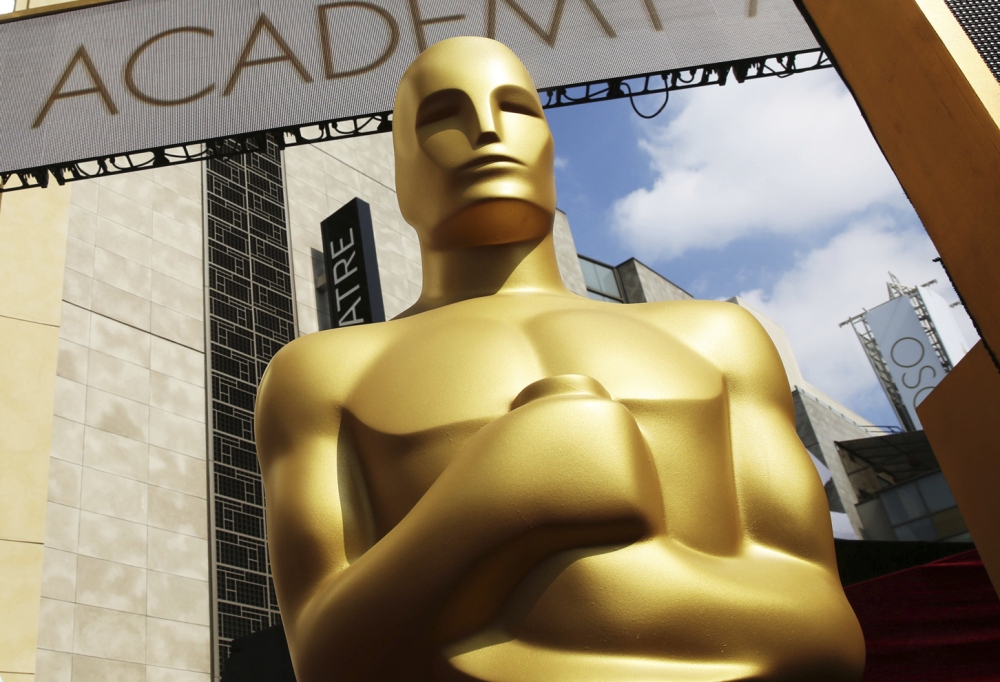 An Oscar statue appears outside the Dolby Theatre ahead of the 2015 ceremony. But who is he really? (Invision/AP)