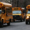 In this photo, three yellow school buses idle in a street in Manhattan's East Village on January 15, 2013.