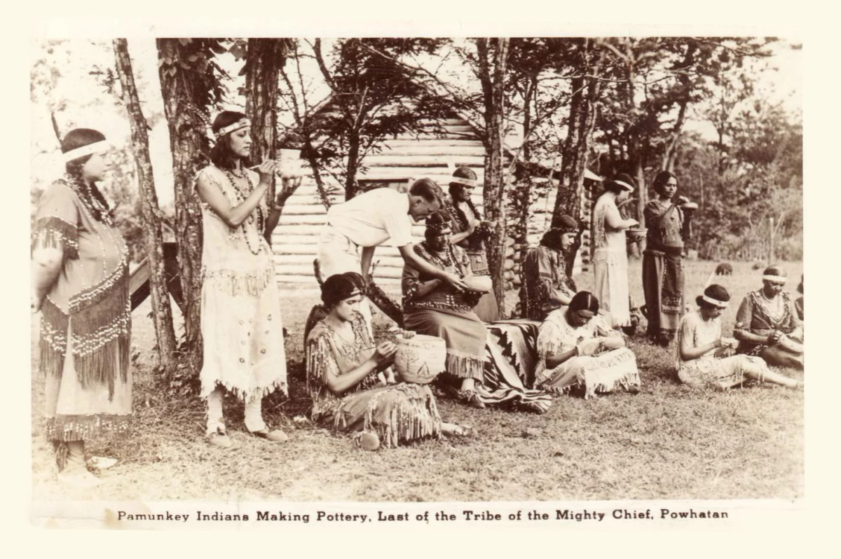 Pamunkey women making pottery at the Pottery School on the Reservation in the early 20th century.