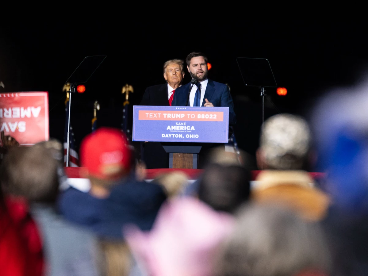 Former President Donald Trump listens to then-Republican US Senate candidate, J.D. Vance speak on stage during a campaign rally, on the eve of the US midterm elections, in Vandalia, Ohio, on November 7, 2022.
