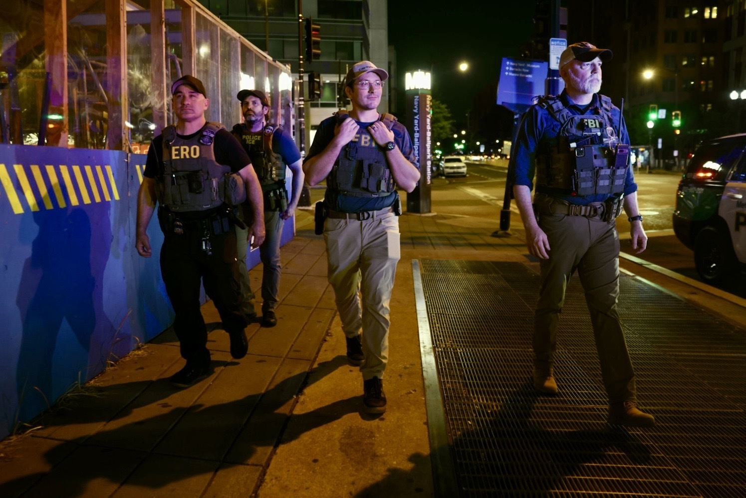 FBI agents and other federal law enforcement agents walk around the neighborhood near the Nationals Stadium in Washington, D.C. on Sunday.