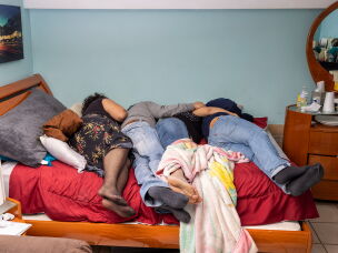 The Villanueva family on their queen-size bed after Jennifer and her brother, Oliver Villanueva, returned for Thanksgiving break in 2021.