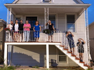 The family watches Fourth of July fireworks from in front of their house in 2022.