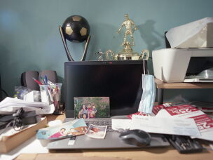 The desk of Mario Villanueva, Jennifer Teresa Villanueva's father, is filled with family photographs of his wife, son and daughter in 2026.