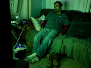Mario Villanueva takes a nap after coming back from work in 2022.