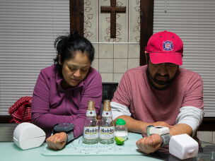 Nelly and Mario Villanueva check their blood pressure after dinner in 2021.