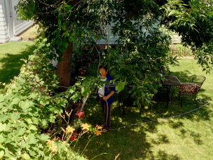 Teresa Chavez waters her garden in 2018.