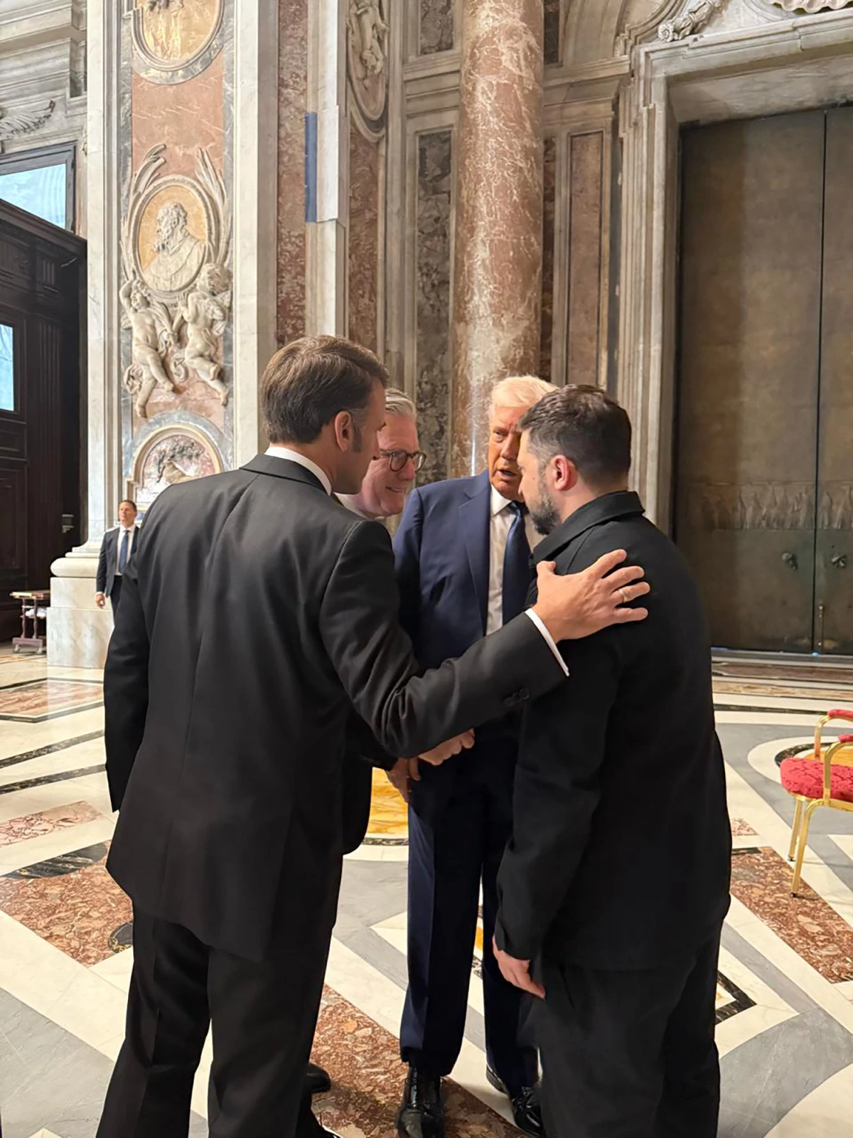 Ukraine's President Volodymyr Zelenskyy, right, President  Trump, second right, French President Emmanuel Macron, left, and British Prime Minister Keir Starmer talk as they attend the funeral of Pope Francis.