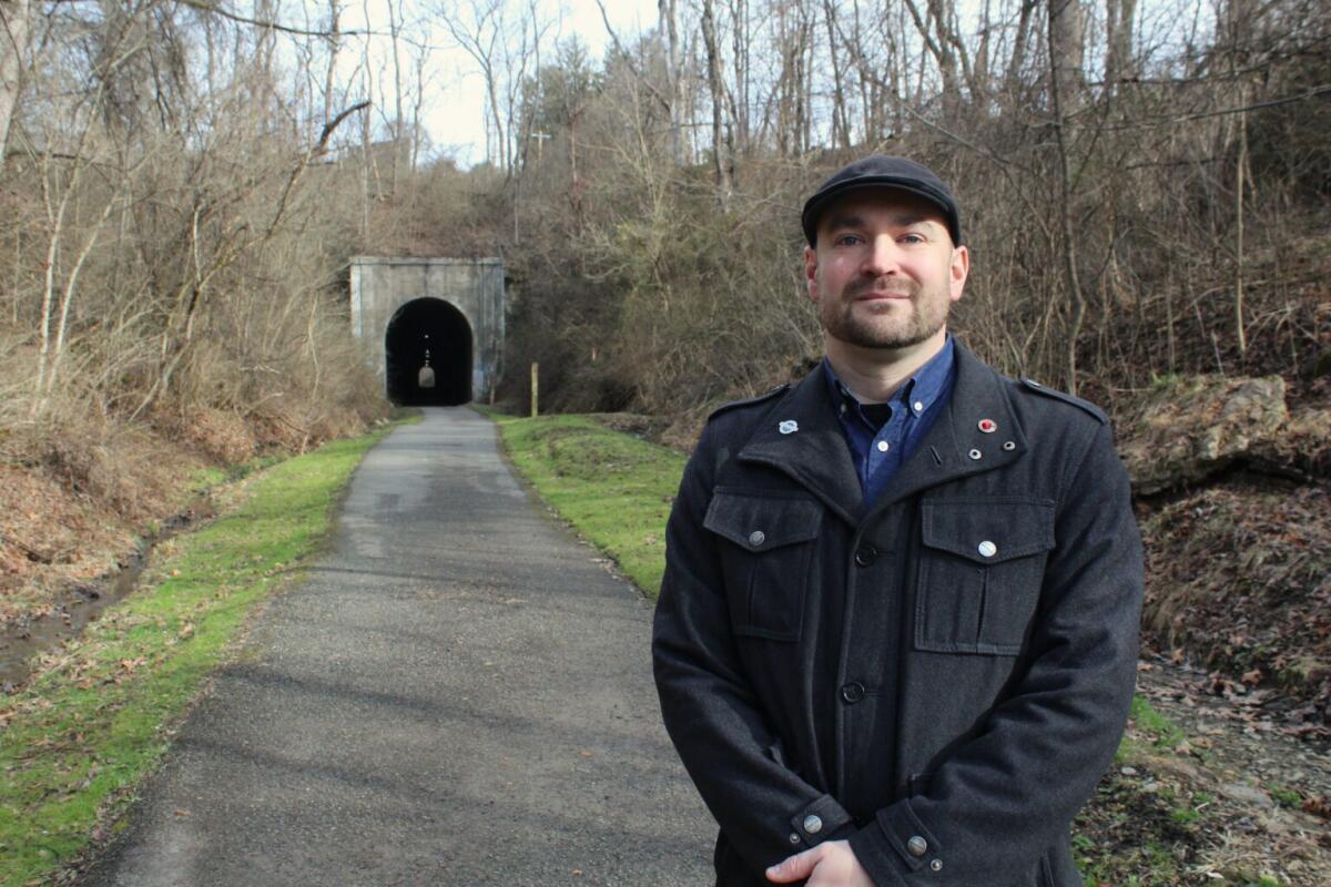 Shae Strait stands in front of the Meredith Tunnel on the Marion County rail trail near the trail's current terminus.