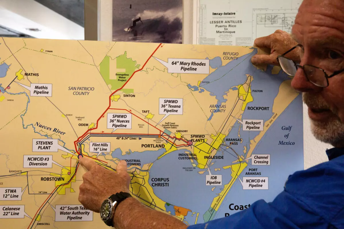 John Michael, vice president of Hanson Professional Services in Corpus Christi, explains a map of Corpus Christi's water supply and distribution system in his office in May.