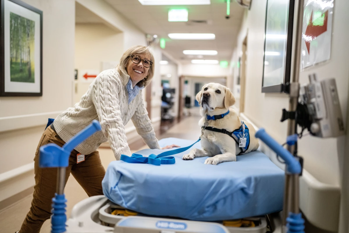 Peppi, a Canine Companion dog, takes a break at Denver's HCA HealthONE Rose medical center with her handler, emergency medicine physician Susan Ryan, in November.