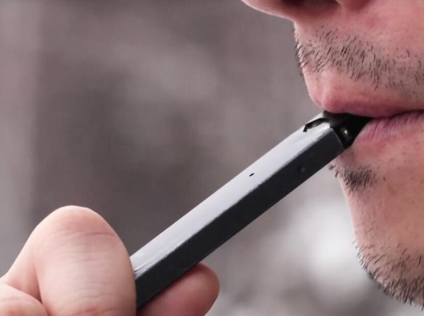A person using a Juul vape.