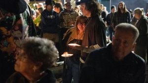 Braxxton Dahm comforts his wife Mickie Dahm during a vigil on Oct. 16, 2026, in downtown Bend, Ore.